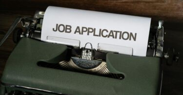 image of a typewriter typing out the words job application | Get A Job in Totonto