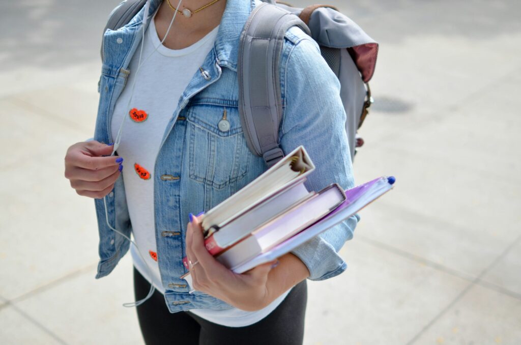 image of a student with books in her hand | Study Masters In Canada With Scholarship For International Students 